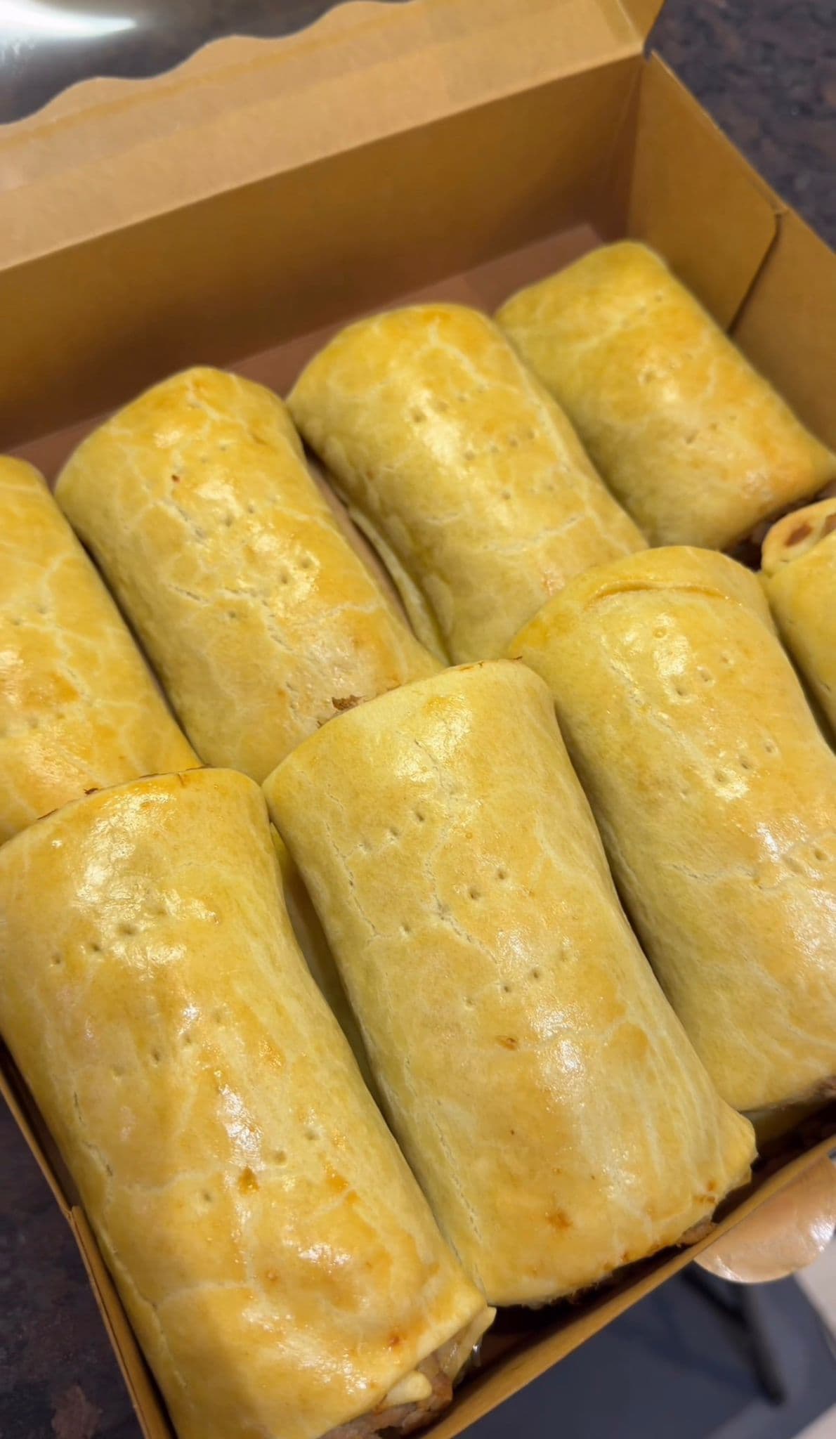 Glossy fish rolls packed in a kraft box